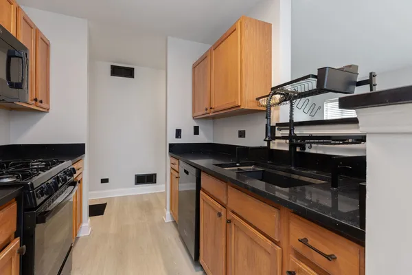 a kitchen with stainless steel appliances granite countertop a stove and a sink