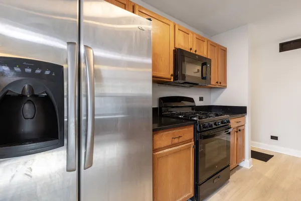 a kitchen with stainless steel appliances granite countertop a stove and a refrigerator