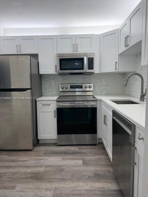 9370 Southwest 8th Street, Unit 418 Boca Raton, FL 33428 - Photo 1 of 19 a kitchen with a stove and a microwave