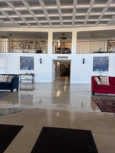 9370 Southwest 8th Street, Unit 418 Boca Raton, FL 33428 - Photo 13 of 19 a lobby with a couch and a fireplace