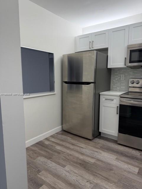 9370 Southwest 8th Street, Unit 418 Boca Raton, FL 33428 - Photo 2 of 19 a kitchen with a refrigerator sink and stove