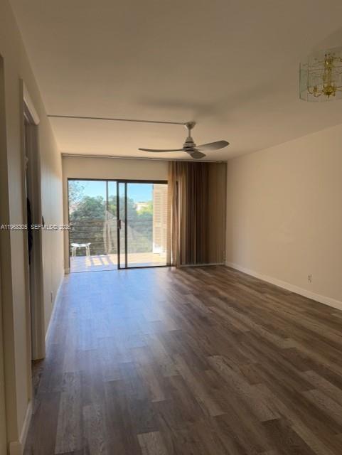 9370 Southwest 8th Street, Unit 418 Boca Raton, FL 33428 - Photo 4 of 19 a view of an empty room with wooden floor and a window