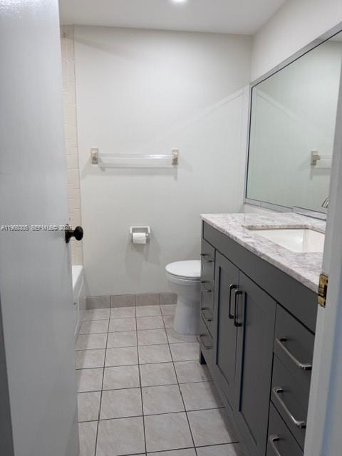 9370 Southwest 8th Street, Unit 418 Boca Raton, FL 33428 - Photo 9 of 19 a bathroom with a granite countertop sink a toilet and a mirror
