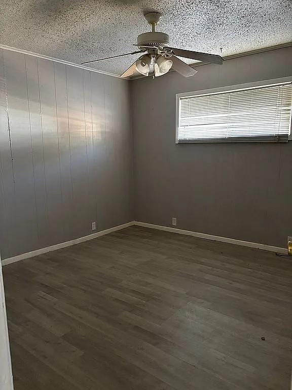 1711 Ash Street Commerce, TX 75428 - Photo 8 of 11 a view of an empty room with wooden floor