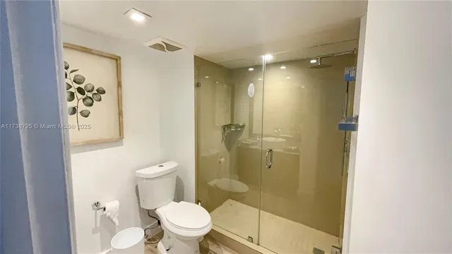 a bathroom with a shower and a toilet