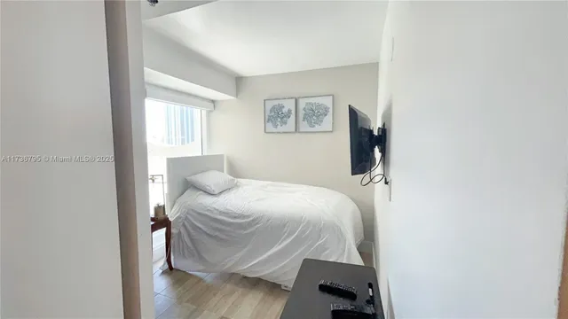 a bedroom with a bed and a window