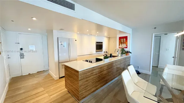 a room with a bed a table and a large mirror with wooden floor