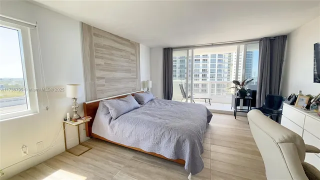 a spacious bedroom with a large bed and a large window