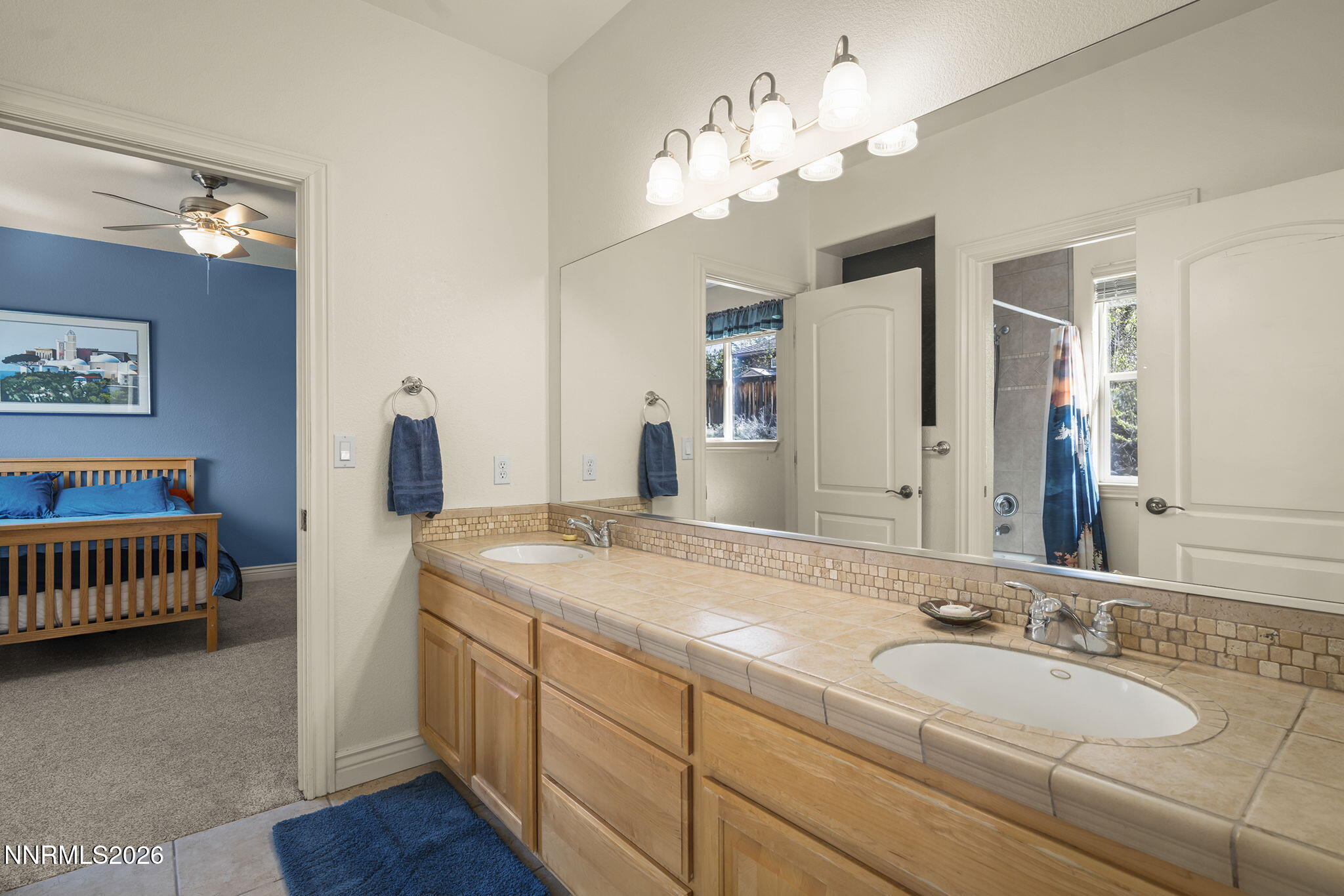 12635 Silver Wolf Road Reno, NV 89511 - Photo 35 of 48 a spacious bathroom with a granite countertop sink and a mirror