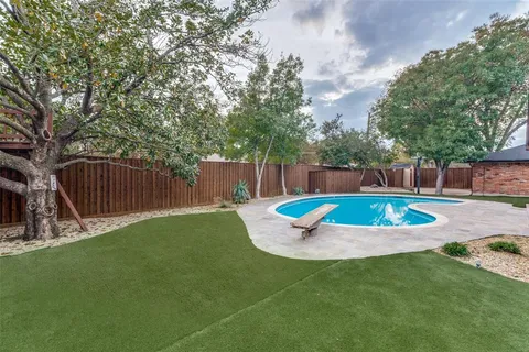 a view of a backyard with swimming pool