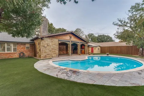 a swimming pool with outdoor seating and yard