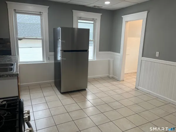 a kitchen with a refrigerator and window