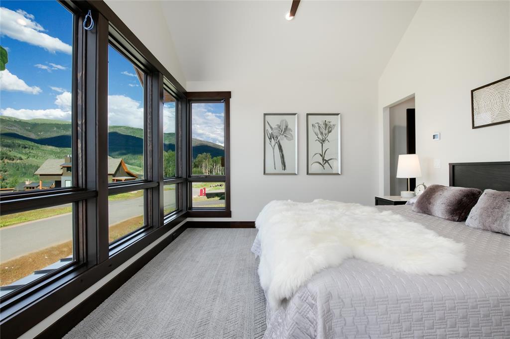 55 Glazer Trail Silverthorne, CO 80498 - Photo 14 of 35 a bedroom with a large bed and a large window