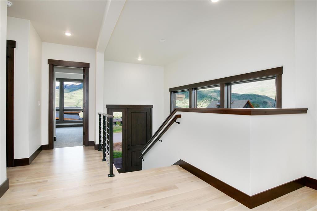 55 Glazer Trail Silverthorne, CO 80498 - Photo 5 of 35 a view of a hallway with wooden floor and staircase