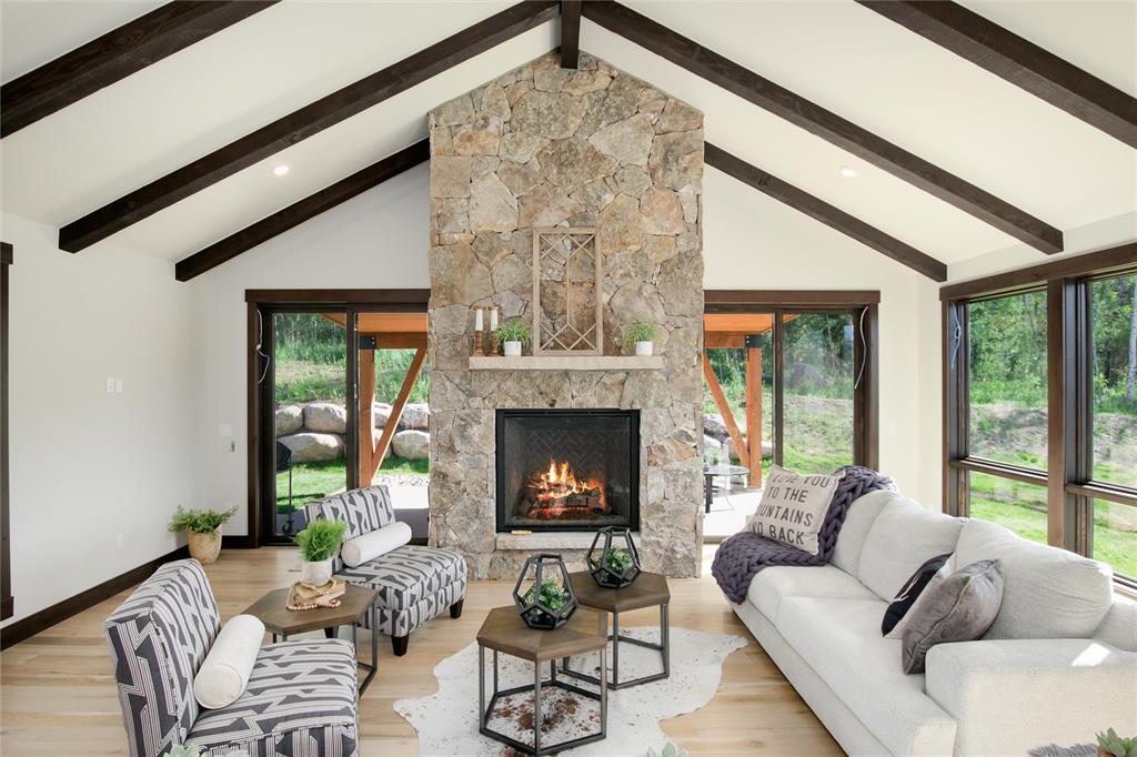 55 Glazer Trail Silverthorne, CO 80498 - Photo 6 of 35 a living room with furniture a fireplace and a floor to ceiling window