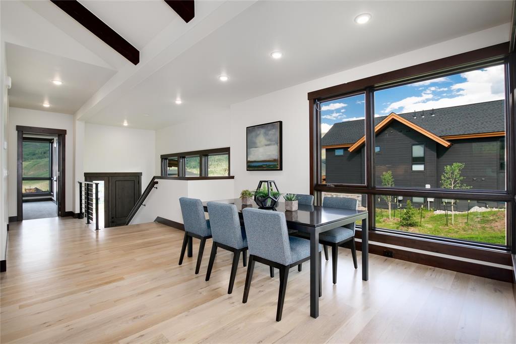 55 Glazer Trail Silverthorne, CO 80498 - Photo 9 of 35 a view of a dining room with furniture window and wooden floor