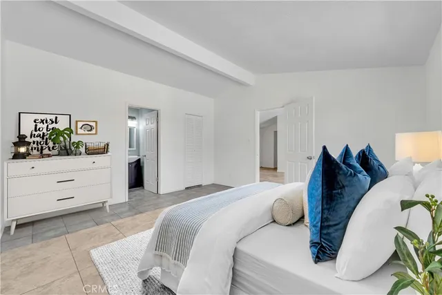 a bedroom with a bed and cabinet