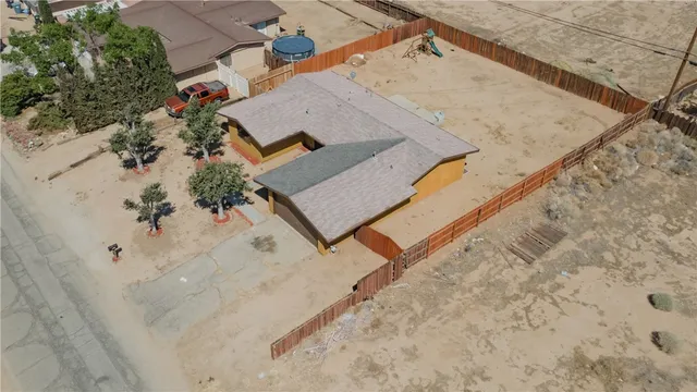 an aerial view of a house with a yard