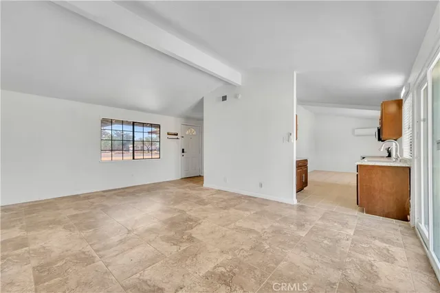 an empty room with a bathroom and mirror