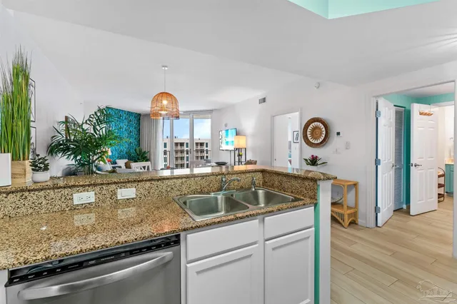 a kitchen with a sink and a stove with living room