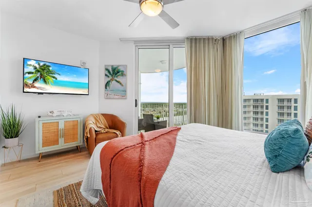 a bedroom with a bed and a large window