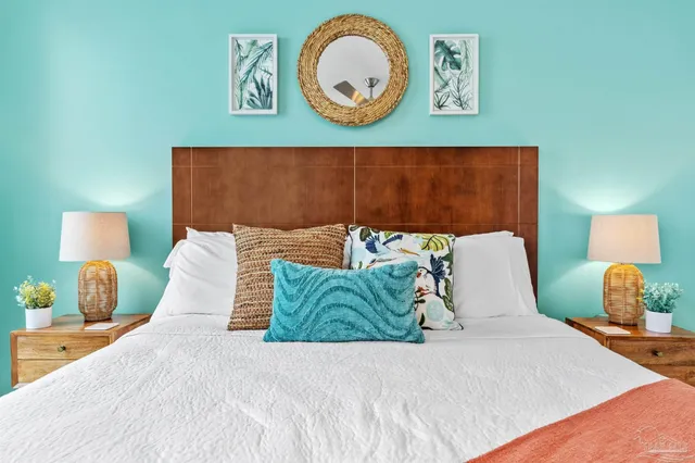 a bed sitting in a bedroom and a lamp