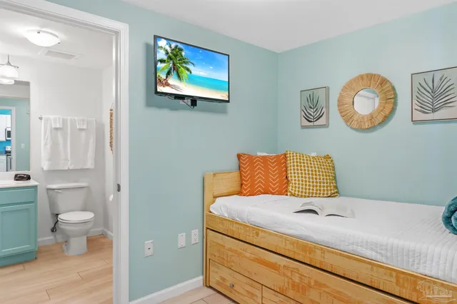 a bedroom with a bed and painting on the wall