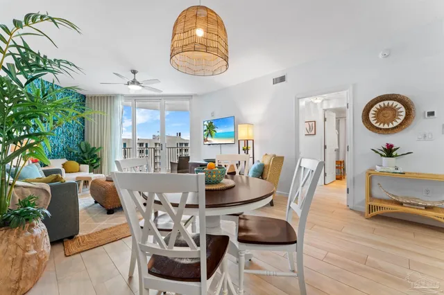 a view of a dining room with furniture and chandelier