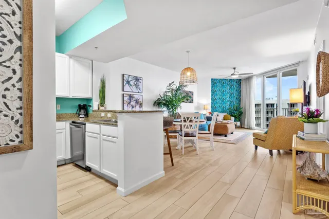 a living room with furniture and a dining table with wooden floor