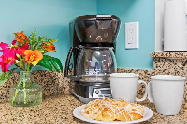 a dining room with furniture and a potted plant