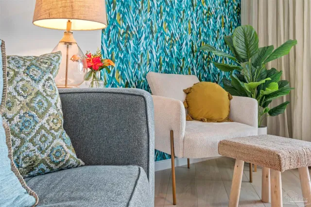 a living room with a couch and a potted plant