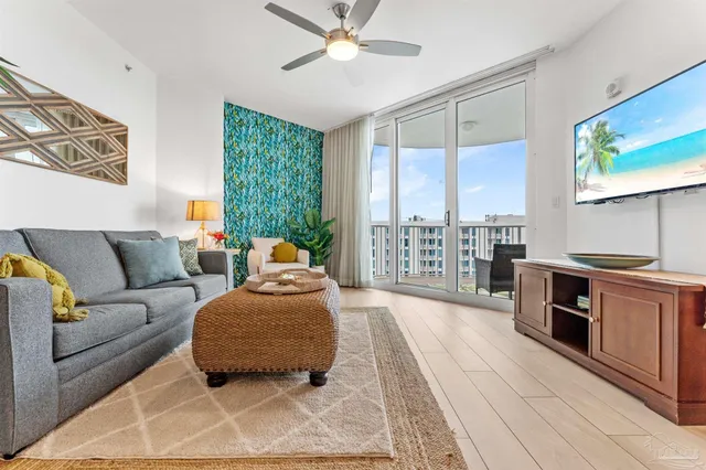 a living room with furniture and a floor to ceiling window