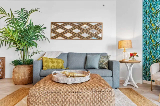 a living room with furniture and a potted plant