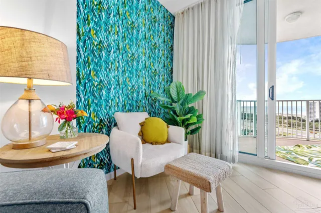 a view of a dining room with furniture and a potted plant