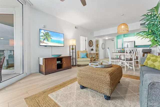 a living room with furniture a couch and a potted plant