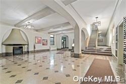 35-21 81st Street, Unit 1C Queens, NY 11372 - Photo 2 of 9 a view of a hallway with wooden floor and furniture