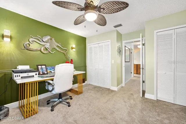 a view of a kitchen with furniture and floor to ceiling windows