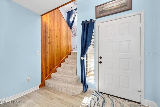 a view of a entryway with wooden floor and door