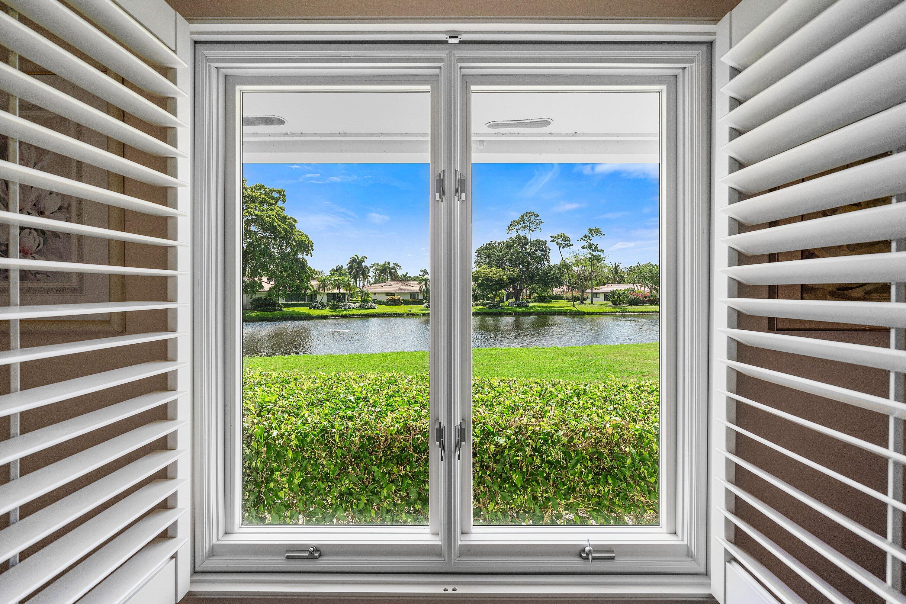 4365 Shell Drake Lane Boynton Beach, FL 33436 - Photo 21 of 56 a view of a room that has a big window and a red door