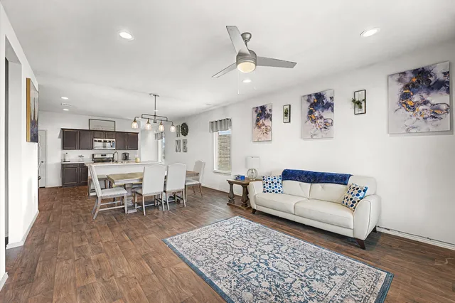 a living room with furniture and a wooden floor