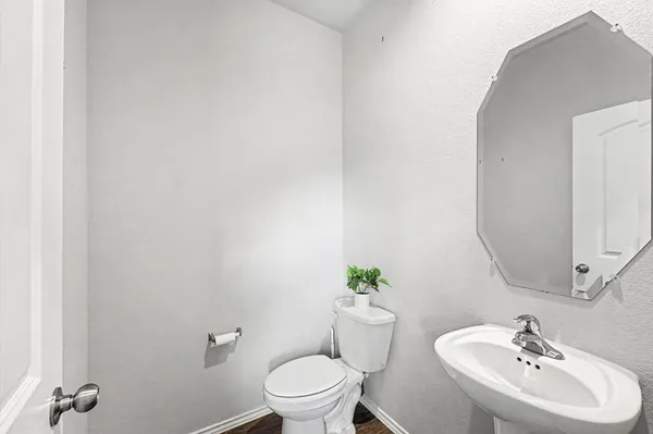 a bathroom with a sink toilet and a mirror
