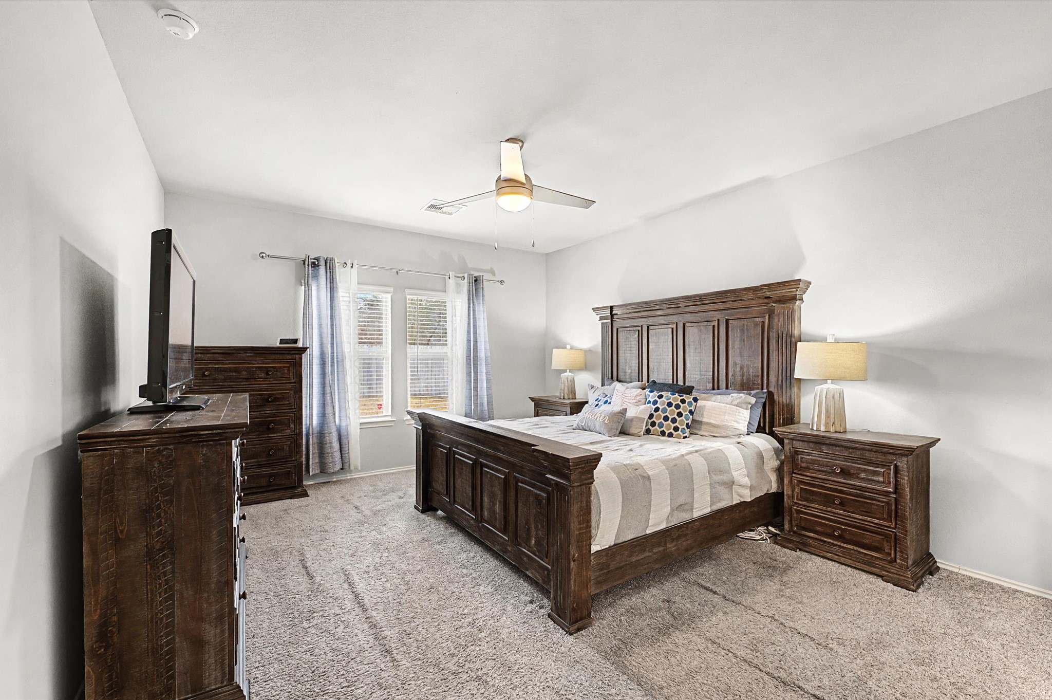 22803 Berthoud Trail Spring, TX 77373 - Photo 15 of 42 a bedroom with a bed dresser and a flat tv screen