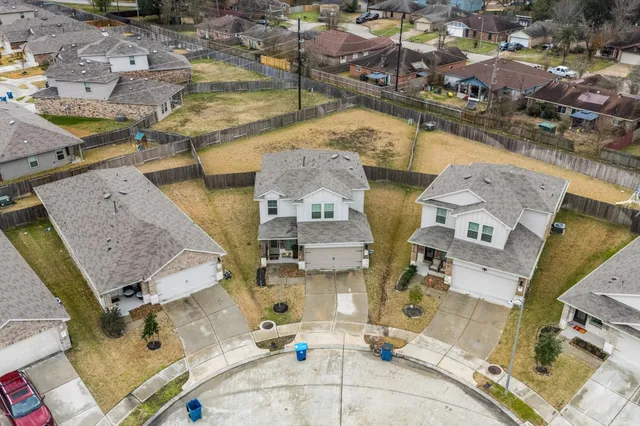 an aerial view of residential houses with outdoor space