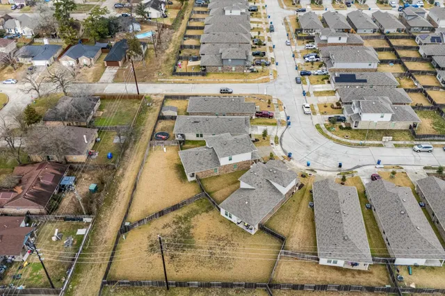 an aerial view of residential houses with outdoor space