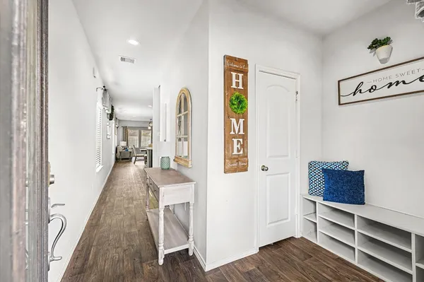 a view of hallway with wooden floor and stairs
