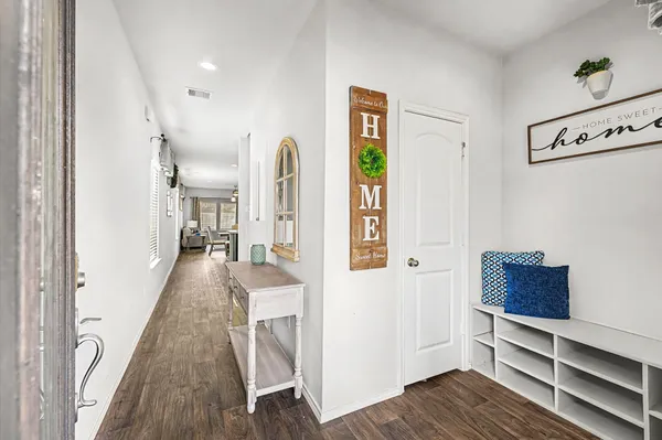 a view of hallway with wooden floor and stairs