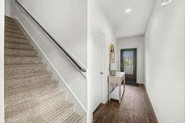 a view of entryway and hall with wooden floor