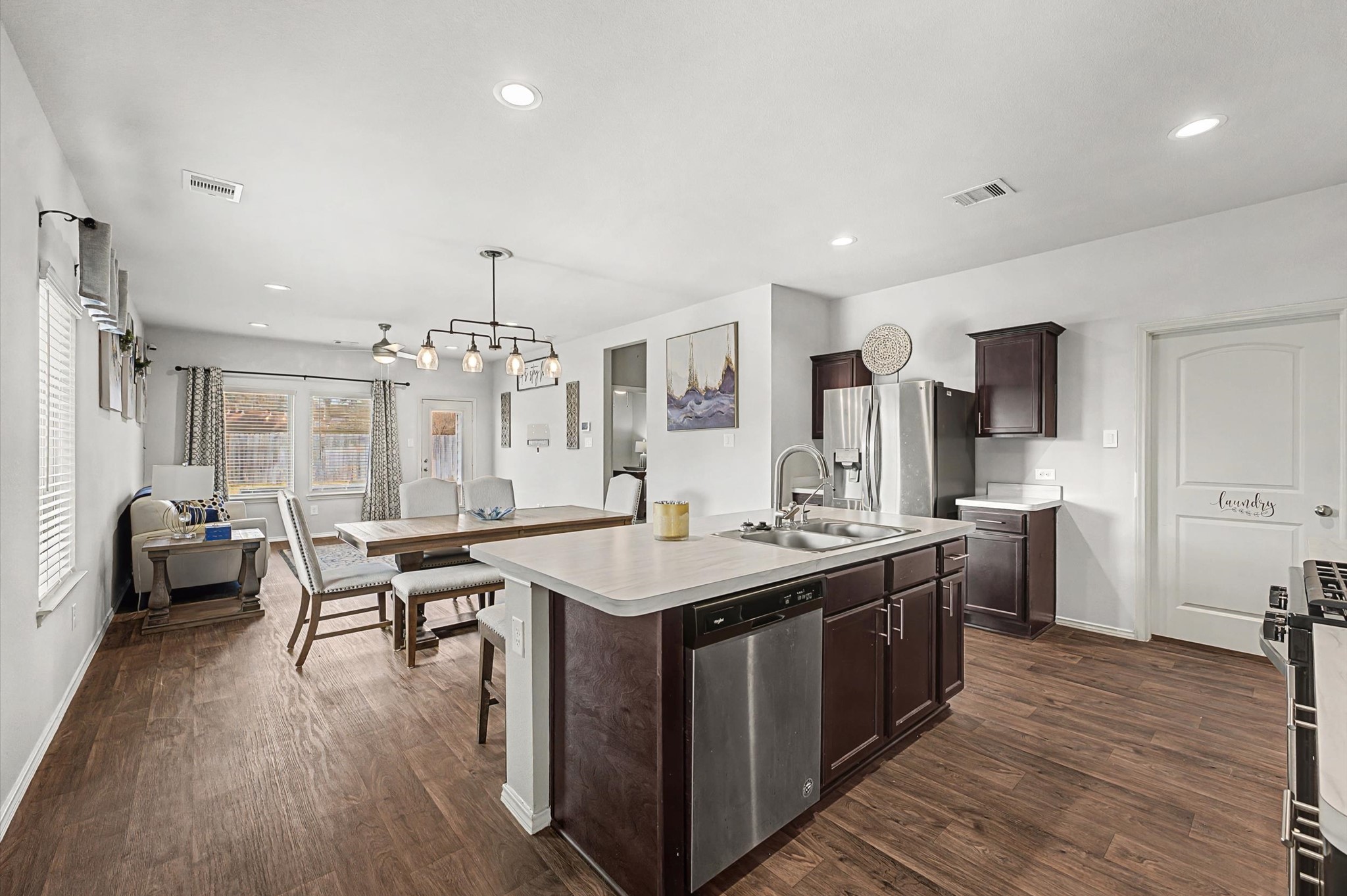 22803 Berthoud Trail Spring, TX 77373 - Photo 9 of 42 a kitchen with a stove a refrigerator a sink dishwasher with a dining table and chairs