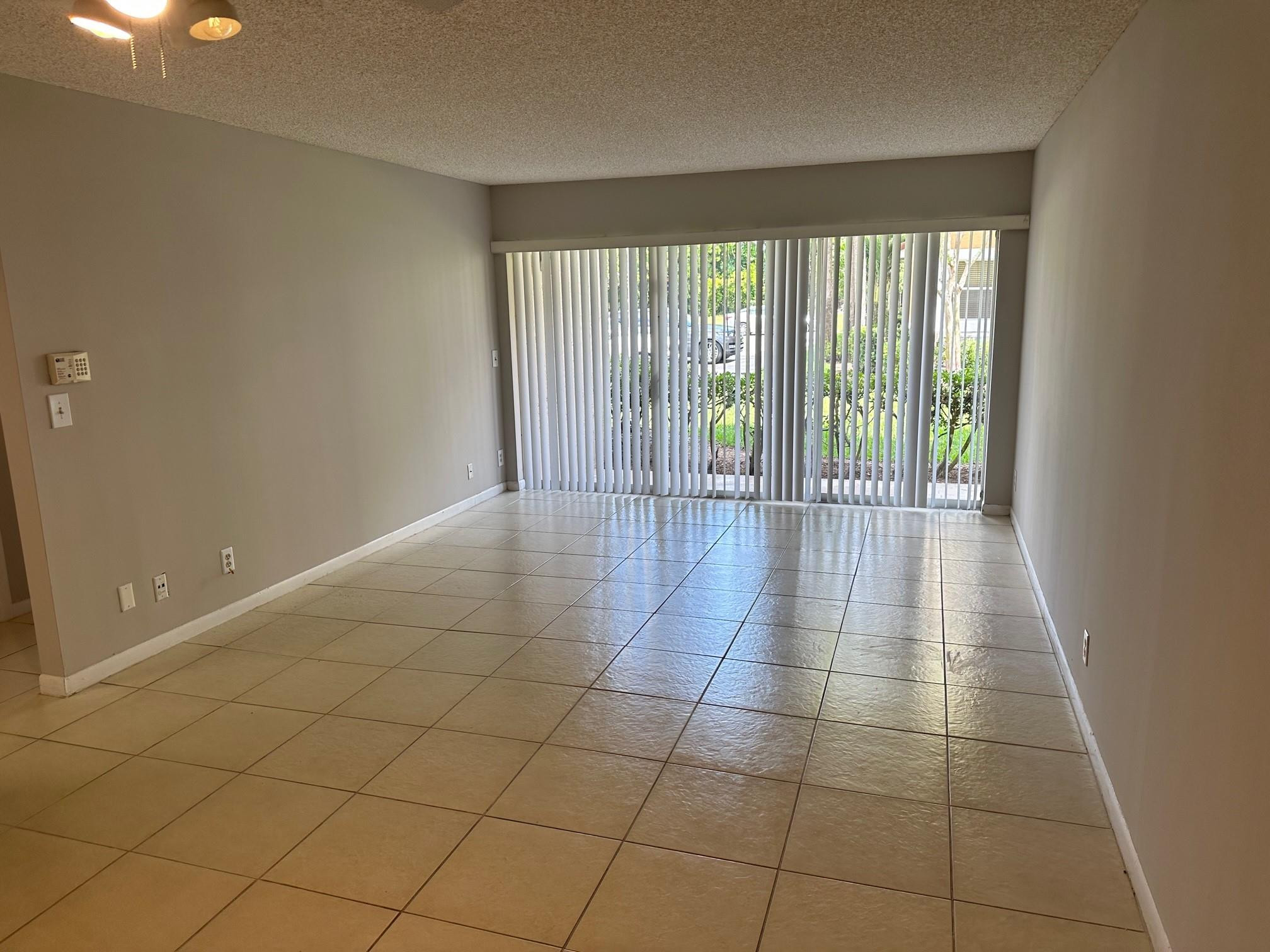 9001 Wiles Road Coral Springs, FL 33067 - Photo 4 of 10 a view of an empty room and window