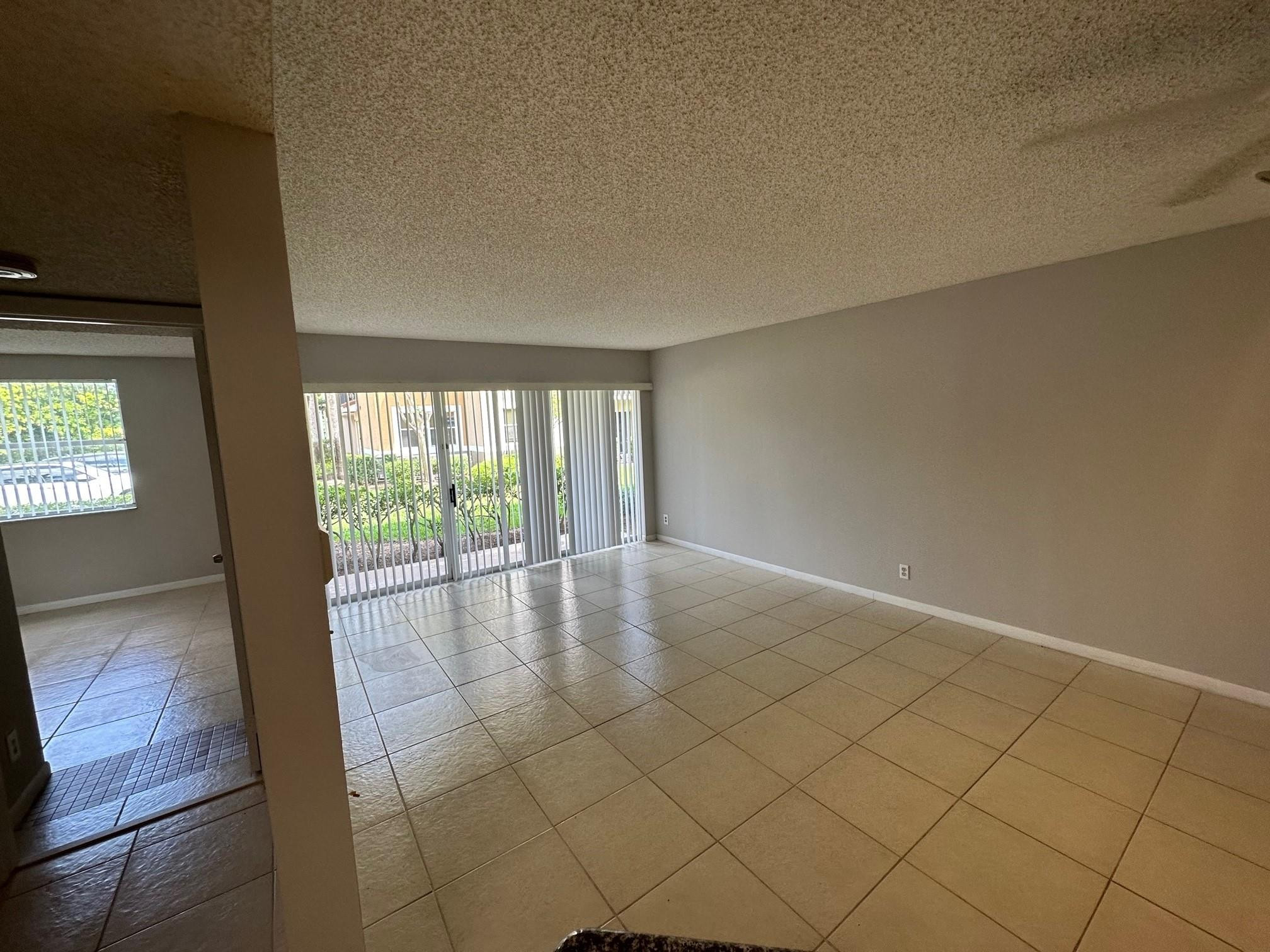 9001 Wiles Road Coral Springs, FL 33067 - Photo 5 of 10 an empty room with windows